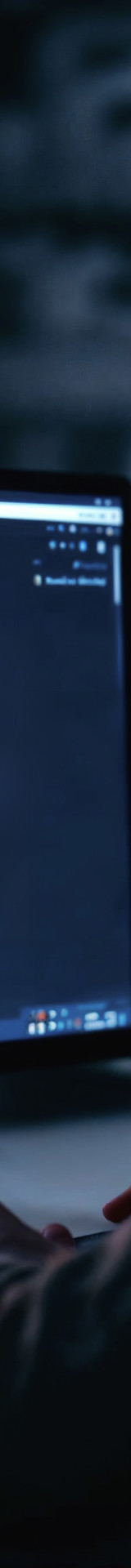 Man Facing Computer Screen Displaying Security Warning Symbol